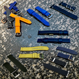 Collection of various watch straps on a textured surface