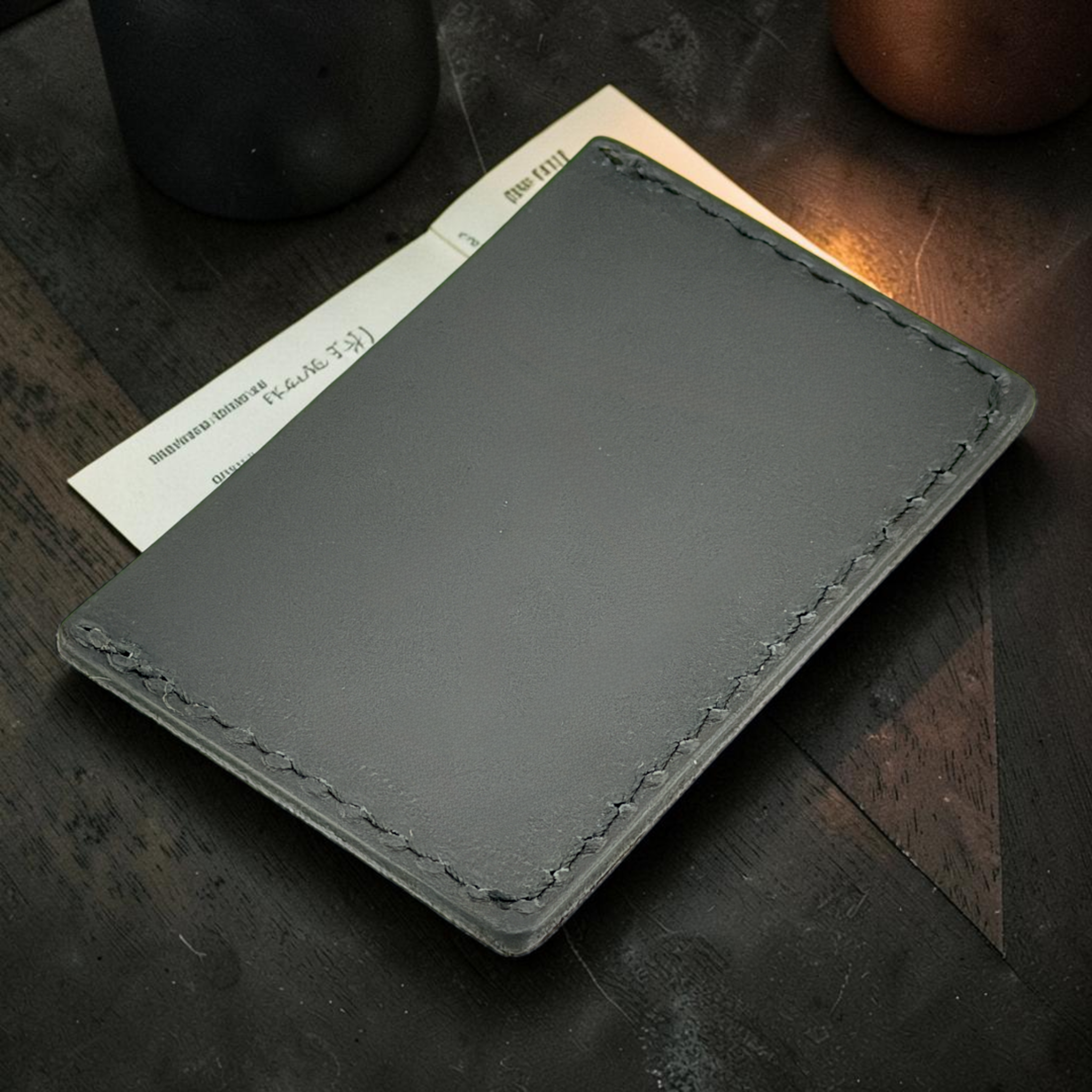 Gray leather wallet on a wooden surface with a blurred background