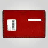 Red leather cardholder with a barcode label on a gray background