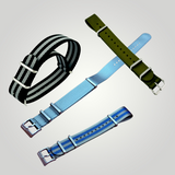 Four watch straps in different colors on a light gray background