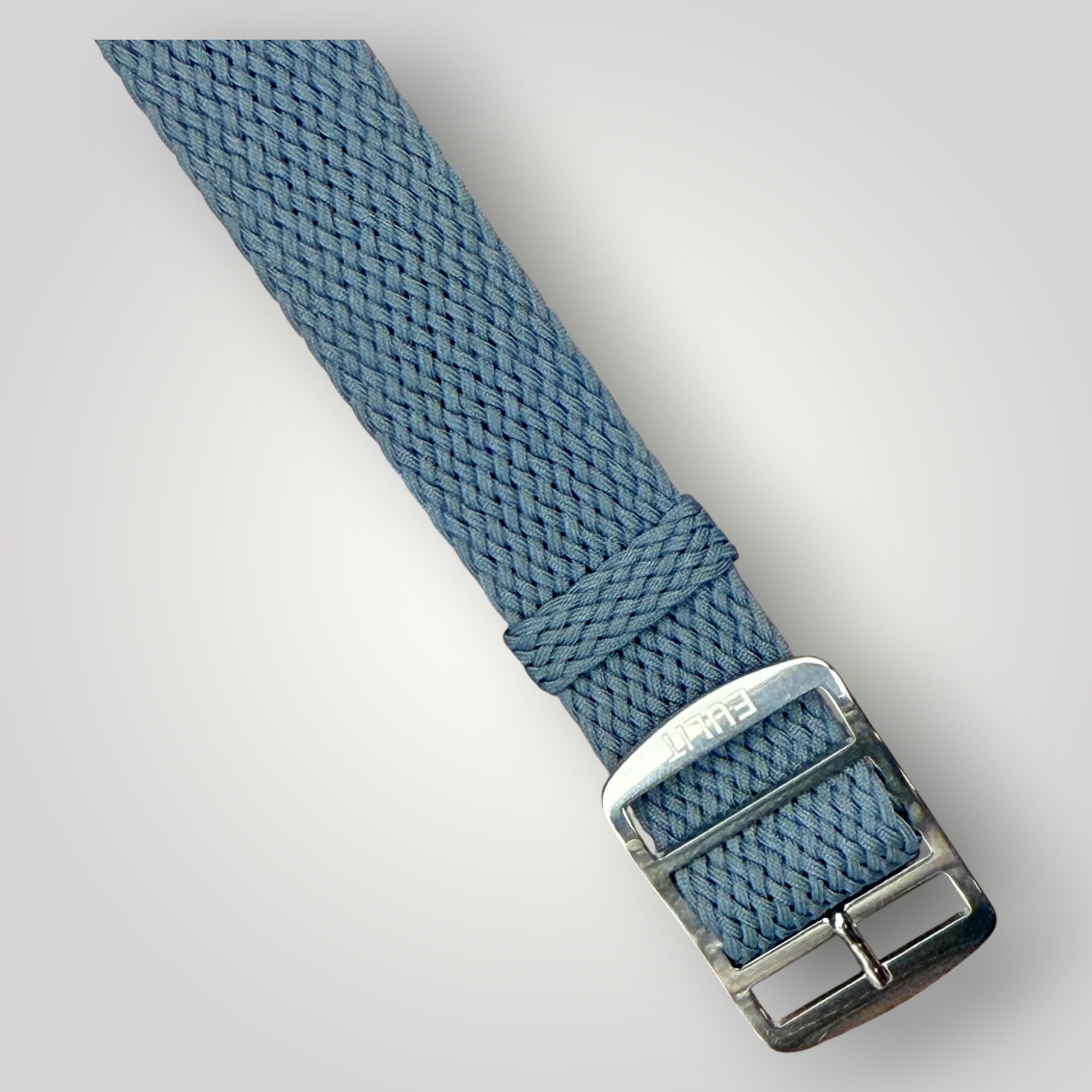 Grey woven watch strap with silver buckle on a light gray background