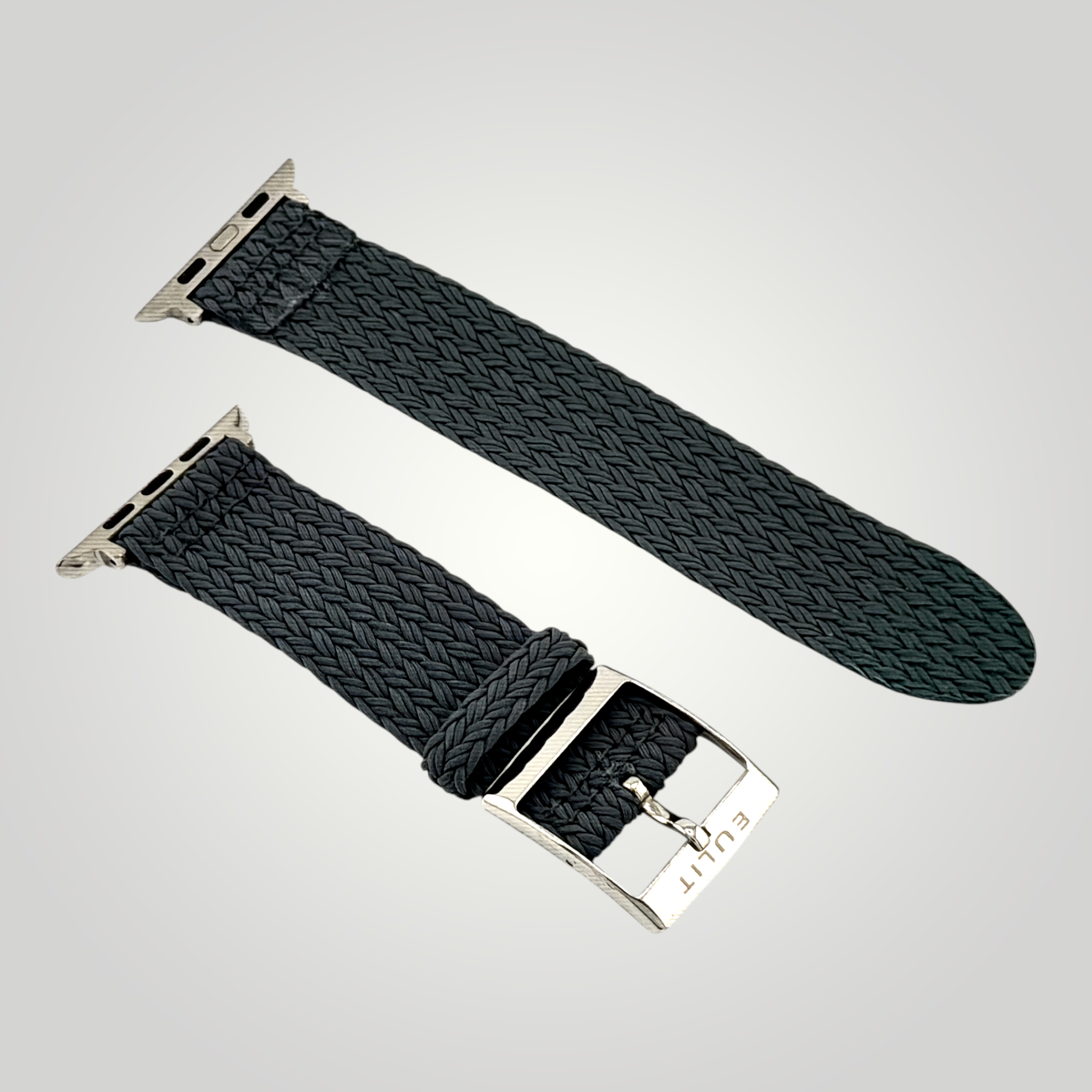 Black woven watch strap with silver buckle on a light gray background