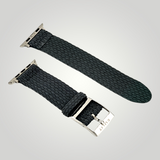 Black woven watch strap with silver buckle on a light gray background